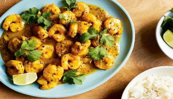 Succulent prawns cooked in a vibrant garlic, lime, and chili butter sauce, served with fresh coriander.